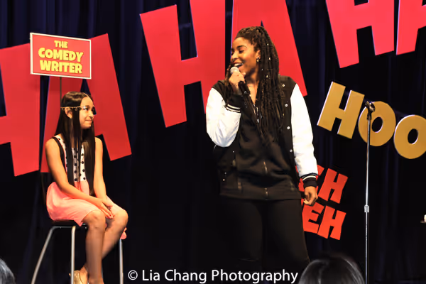 Project member Magalis Fabian Vinas, age 11, in the Comedy Writer chair while Jessica Photo