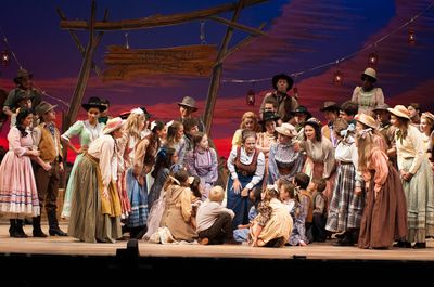 Aunt Eller (Nedra Dixon) declares the Farmer and the Cowman should be friends.  Photo