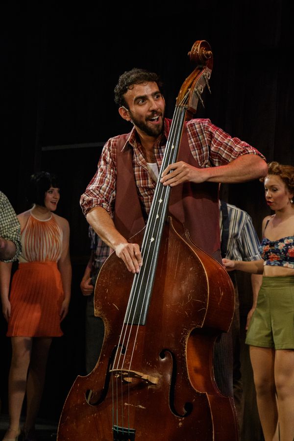 Lethargic cowboy Moose (Charles South) finds energy in the rhythm of his bass Photo