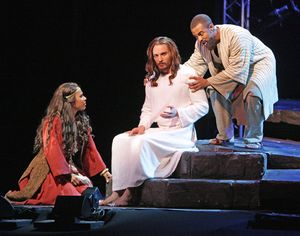 Mary Magdalene (Erin Clemons) sits at the feet of Jesus (Thaddeus Pearson) as Judas ( Photo