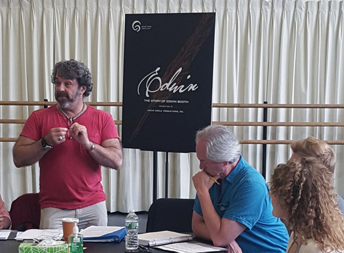 Christopher Scott (standing) at the table read at 