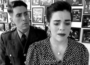 Mike works to comfort Susan as she questions her husband's activities. â€” with  Photo