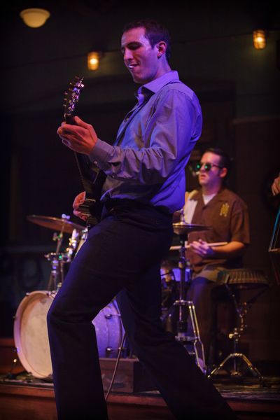 Carl Perkins (James Bock) strums the strings while having a smoke Photo