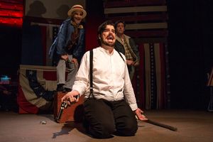 (L to R) Will Shupe as The Proprietor, Chris Kerrigan kneeling as John Wilkes Booth, Levi Gotsman as The Balladeer. @ BroadwayWorld (L to R) Will Shupe as The Proprietor, Chris Kerrigan kneeling as John Wilkes Booth, Photo