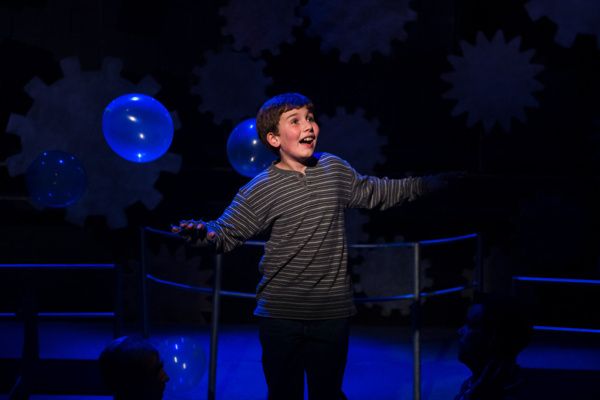 Holden Browne flying as Charlie Bucket in Roald Dahl's Willy Wonka at NextStop Theatr Photo