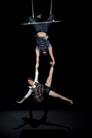 David Corlew holds Kate Braland in trapeze act Photo