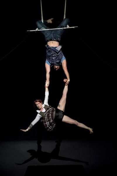 David Corlew holds Kate Braland in trapeze act Photo