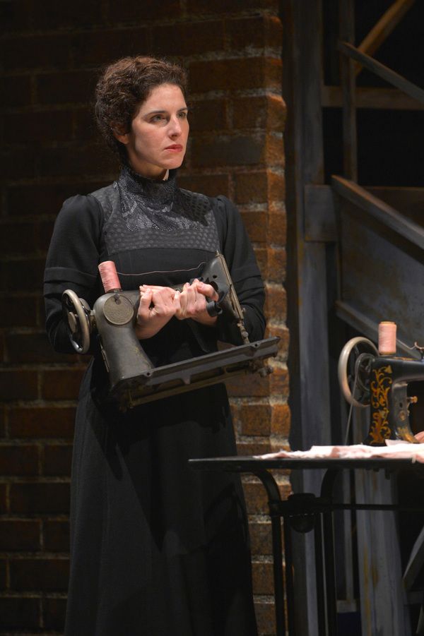 Frustrated from her time in the sweatshop Rebecca (Kyra Miller) takes her sewing mach Photo