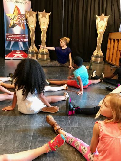 Kids group at Actors Connection Performing Arts Camp stretch with Felicia Finley befo Photo