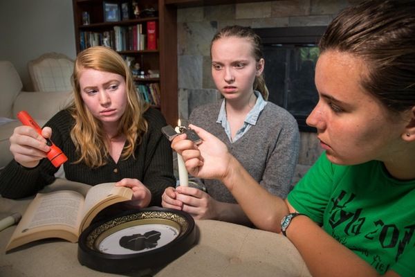 Three teen friends attempt to conjure spirits in a secret midnight ceremony, in â€ Photo