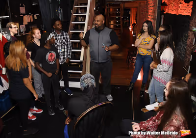 James Monroe Iglehart with students Photo