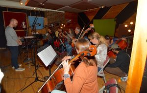 Steve Malone conducts The string section that includes- Adda Kridler (Violin)m Tallie Photo