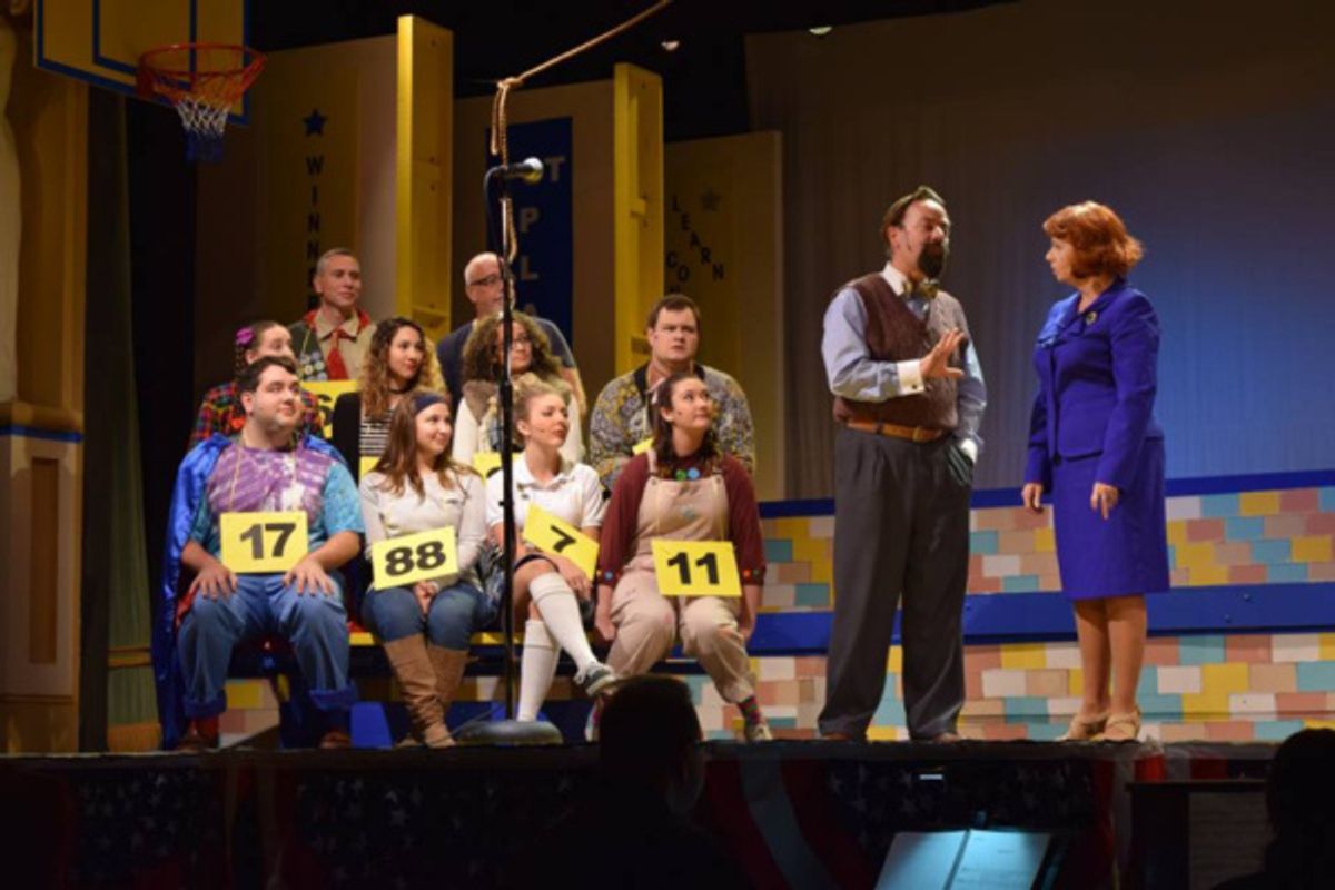 The 25th Annual Putnam County Spelling Bee cast and volunteers are led through the competition by the Bee's moderator, Rona Lisa Peretti (Chikita Wallace) and judge/word pronouncer Vice Principal Douglas Panch (Tim Koob) at 