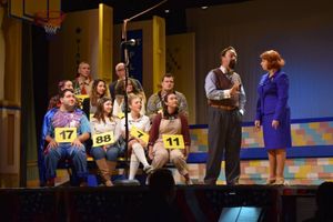 The 25th Annual Putnam County Spelling Bee cast and volunteers are led through the competition by the Bee's moderator, Rona Lisa Peretti (Chikita Wallace) and judge/word pronouncer Vice Principal Douglas Panch (Tim Koob) @ BroadwayWorld The 25th Annual Putnam County Spelling Bee cast and volunteers are led through the co Photo