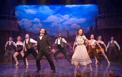 Danny Gardner as Bobby Child and Ashley Spencer as Polly Baker (center), and the ense Photo