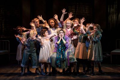 Carrie Hitchcock, center (Miss Hannigan) performs with the SKY cast in rehearsal for  Photo
