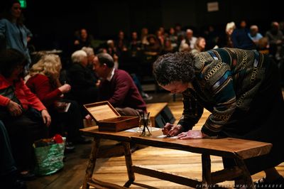Mont Chris Hubbard plays music as Merideth Kaye Clark and Leif Norby gather winter me Photo