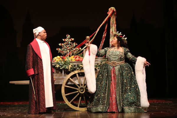 Craig Wallace as Ebenezer Scrooge and Rayanne Gonzales as the Ghost of Christmas Pres Photo