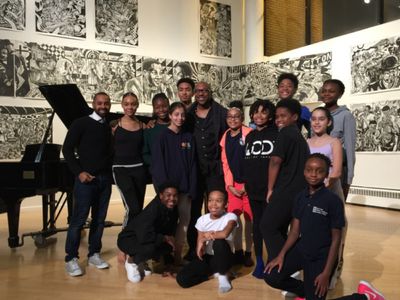 Surrounded by the next generation of hopeful performers, Alton Fitzgerald White poses Photo