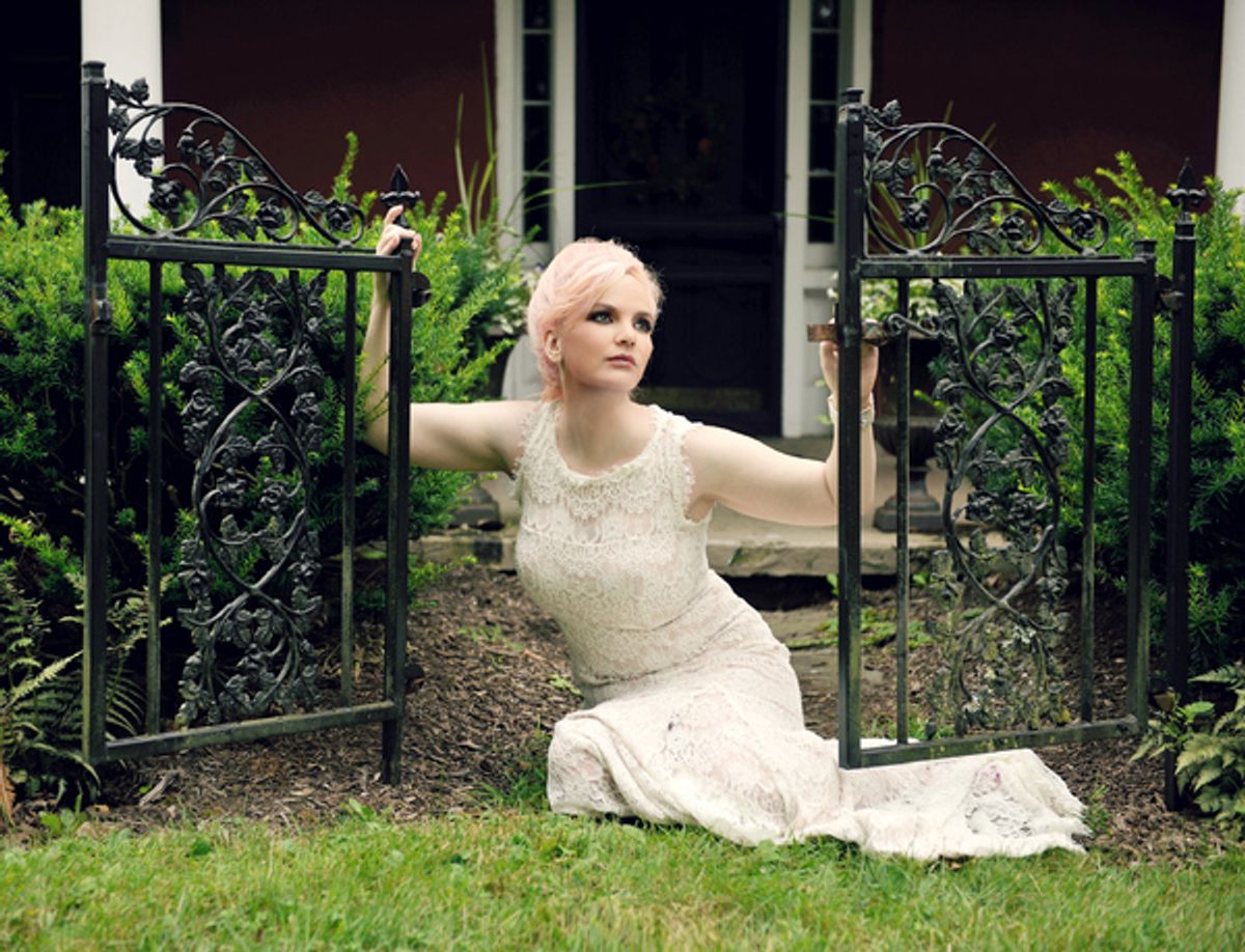 Doreen Taylor kneels at the original gate to the formal front door to Highland Farm, Oscar Hammersteinâ€™s former home and workplace at 