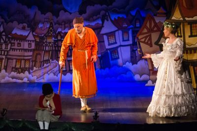 Scrooge (Eric Fletcher) gazes at his younger self with the assistance of the Ghost of Photo