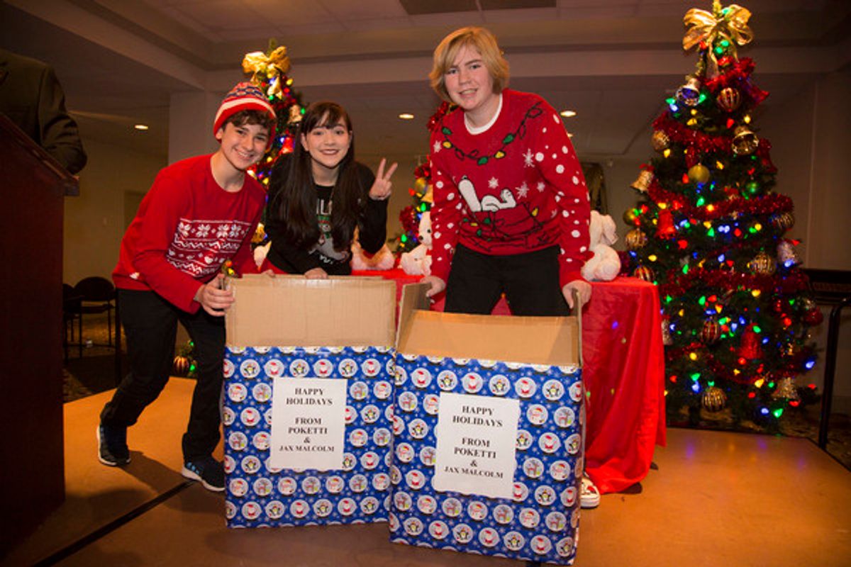 Jax Malcolm, Chloe Noelle and Conner Dean pepare to hand out POKETTI to all of the students at 