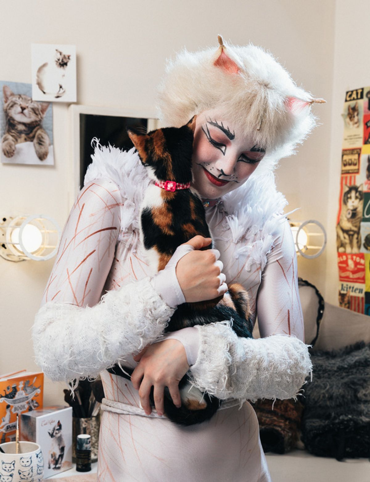 Claire Rathbun of the CATS cast shares a hug backstage with a shelter kitten at 