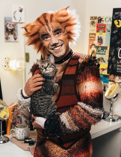 Aaron J. Albano of the CATS cast and an adoptable shelter kitten from The Humane Soci Photo