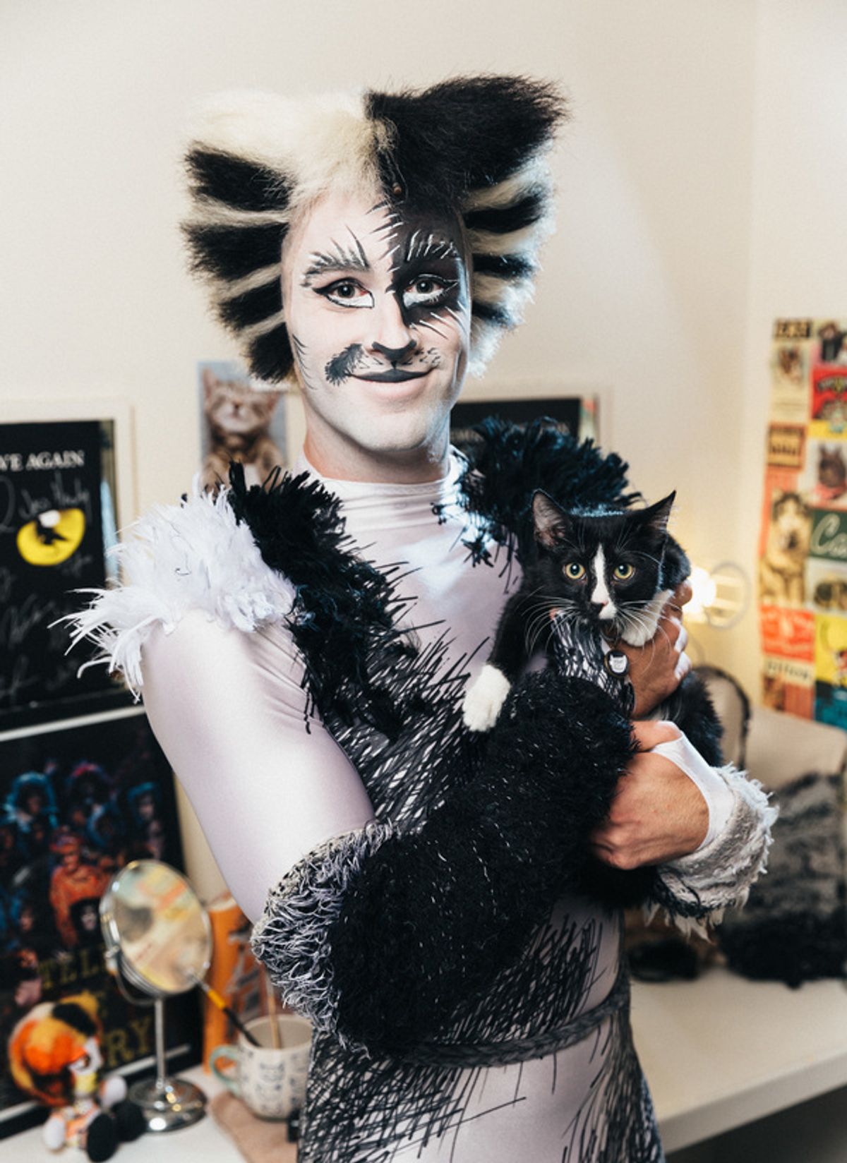 Sam Lips of the CATS cast poses alongside adoptable shelter cat from The Humane Society of New York shelter at 
