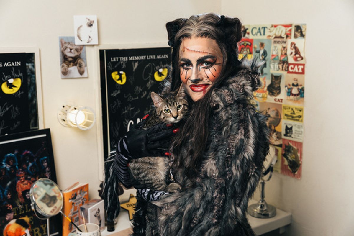 Mamie Parris of the CATS cast and an adoptable shelter cat share a moment backstage at 