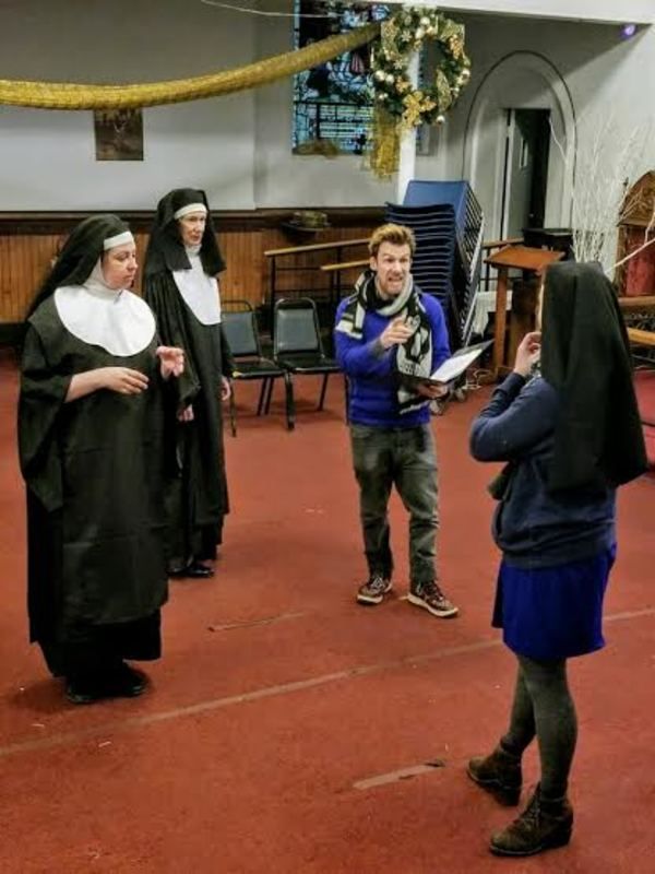 Director Peter Darney with members of the cast Photo