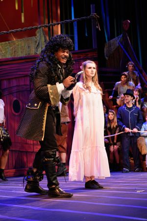 Captain Hook (McLeod Buckham White) enjoys holding Wendy (Madison Thompson) captive before she walks the plank. @ BroadwayWorld Captain Hook (McLeod Buckham White) enjoys holding Wendy (Madison Thompson) captive b Photo