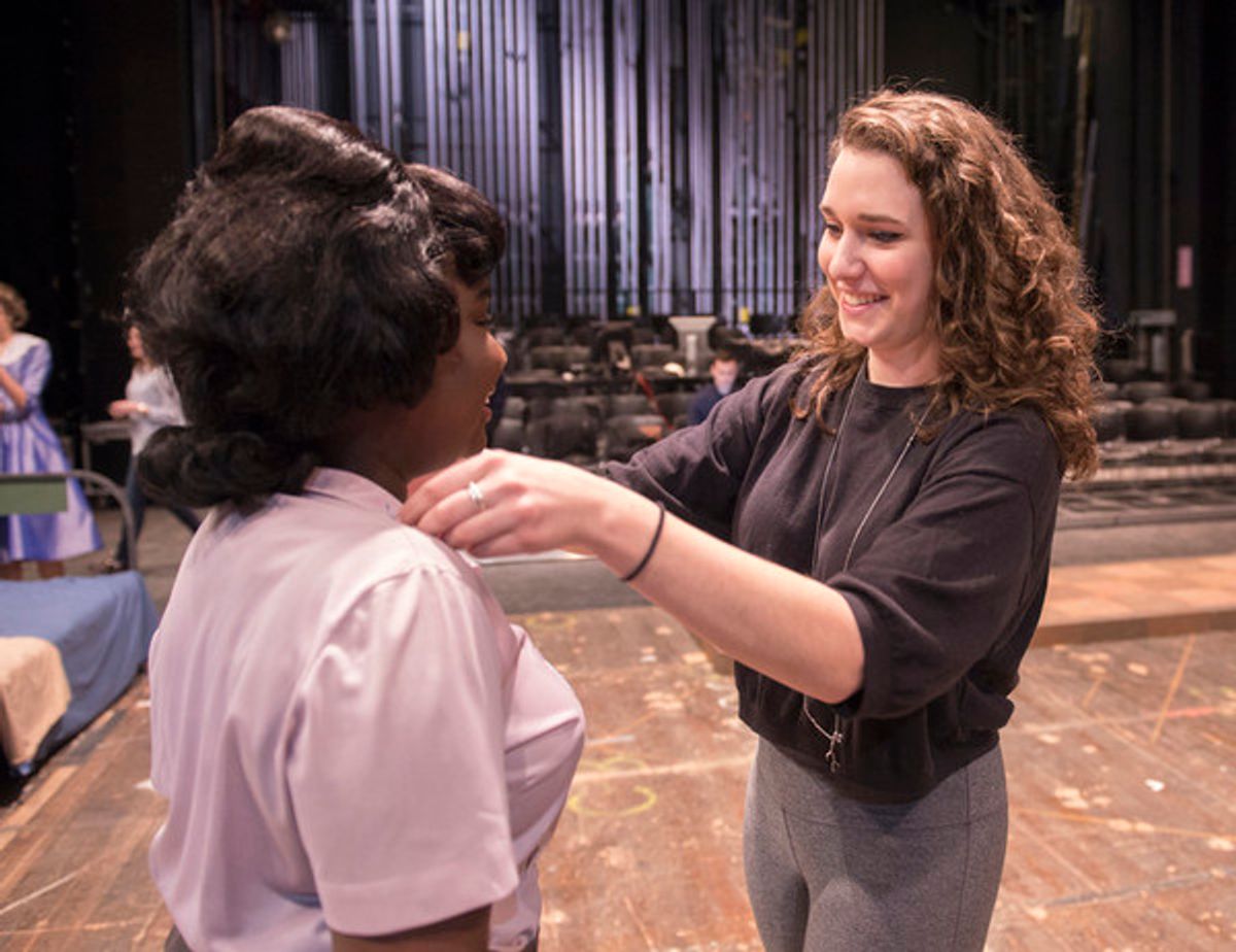 Costume designer Emma Dickerson, right, helps cast member Amina Faye with her wardrobe prior to rehearsal for the Penn State Centre Stage production of Love in Hate Nation. at 