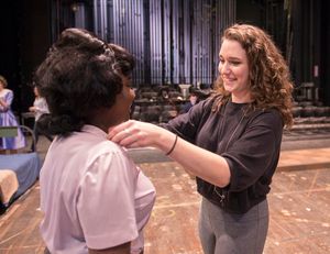 Costume designer Emma Dickerson, right, helps cast member Amina Faye with her wardrobe prior to rehearsal for the Penn State Centre Stage production of Love in Hate Nation. @ BroadwayWorld Costume designer Emma Dickerson, right, helps cast member Amina Faye with her wardrob Photo