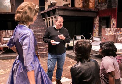 Director John Simpkins discusses notes with members of the cast of Love in a Hate Nat Photo