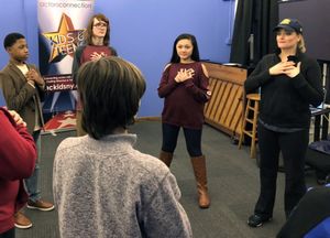 Broadway's Gaelen Gilliland warms up the group of students before teaching them a mus Photo