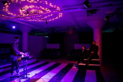 Ben Church as Feste, Alison Russo as Viola, and Leo Castro as Orsino Photo