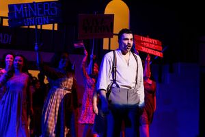 Michael McCray (Cha) and the Evita ensemble Photo