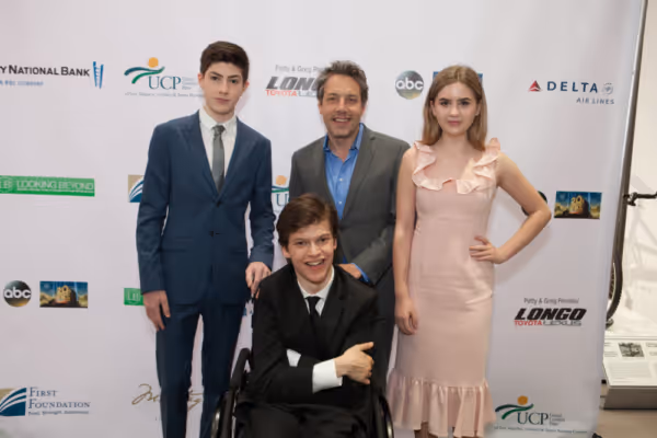 Mason Cook, John Ross Bowie and Kyla Kenedy flank Micah Fowler at United Cerebral Pal Photo