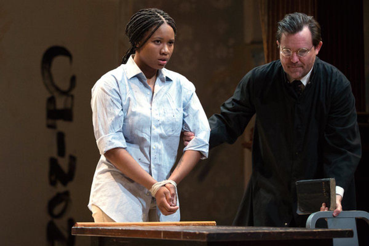The Inquisitor (Eric Tucker) leads the accused Joan (Dria Brown) to her seat to stand trial at 