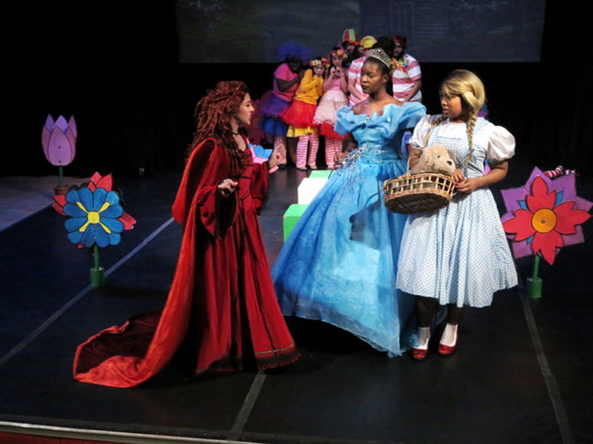  Emily Ramirez (Wicked Witch of the West), Barbyly Noel (Glenda), Taylor-Rey Rivera (Dorothy).  Behind:  Minchkin Ensemble. at 