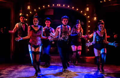 Alex Nee as The Emcee (center) with the ensemble star in the Celebration production o Photo