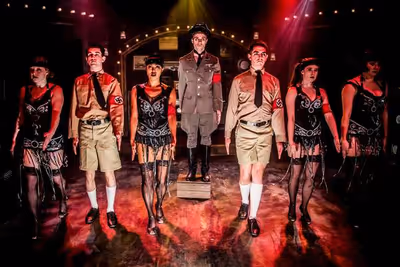 Alex Nee (center) as the Emcee stars with the ensemble star in the Celebration produc Photo