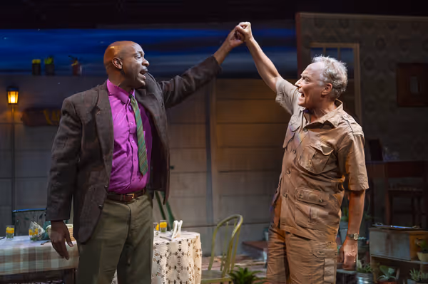 L-R: Friends Steve (Adrian Roberts) and Piet (Victor Talmadge) enthusiastically recit Photo