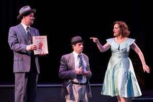 L-R: Mickey (Jim Stanek), Fred (Gabriel Marin) and Natalie (Donna Vivino) explain the Red Channels during a benefit performance in "FINKS" presented by TheatreWorks Silicon Valley at the Mountain View Center for the Performing Arts June 6 to July 1, 2018. @ BroadwayWorld L-R: Mickey (Jim Stanek), Fred (Gabriel Marin) and Natalie (Donna Vivino) explain the Photo