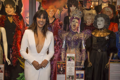 Honoree Stephanie Beatriz with costumes on display worn by LGBTQ Icons and Legends Photo