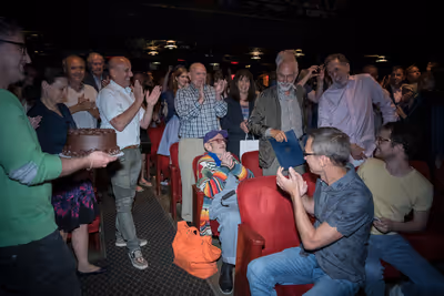 The audience singing Happy Birthday to Larry Kramer Photo