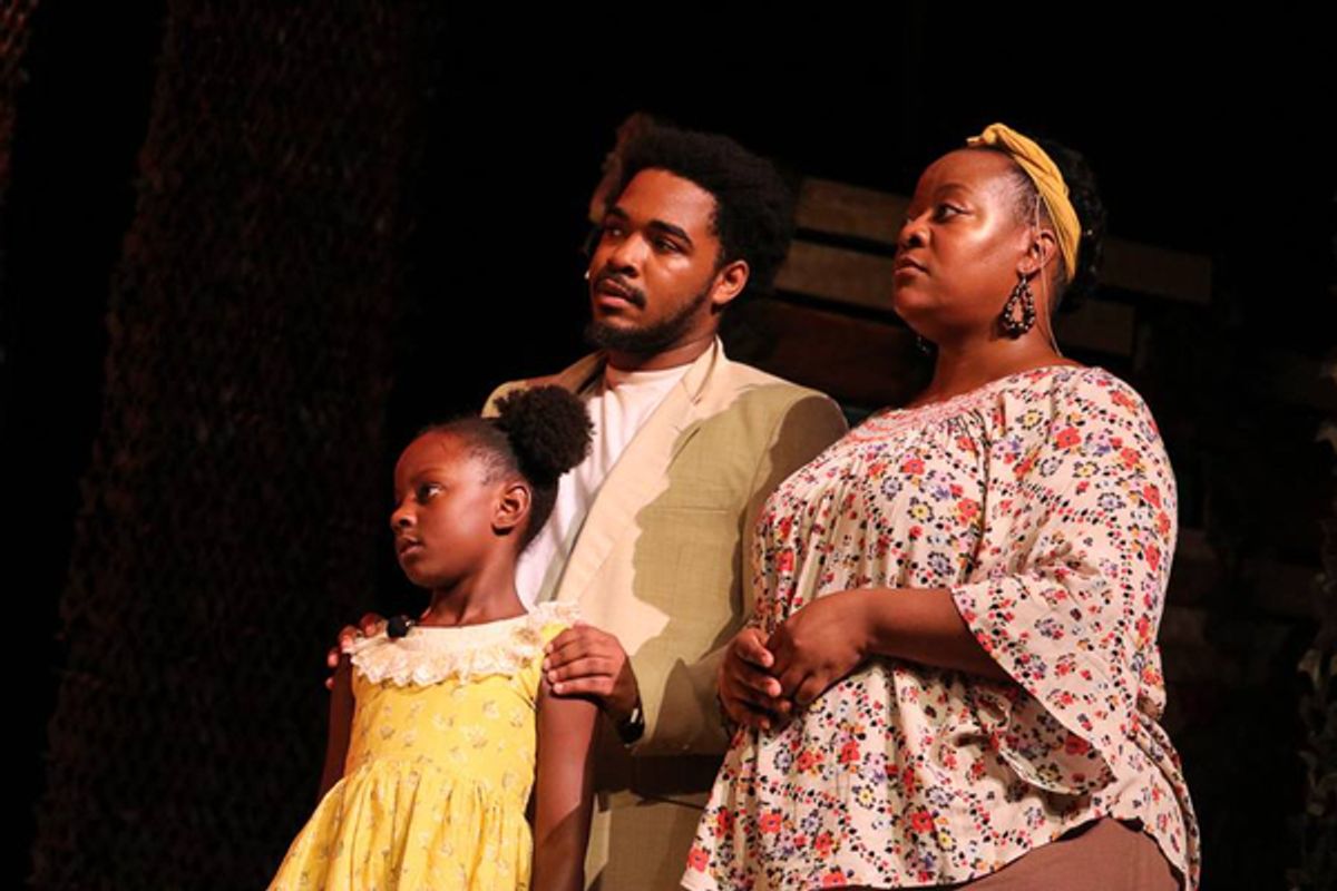 Little Ti Moune (Poet Lewis) is found in a tree after a flood by Tonton Julian (Japrice Green) and Mama Euralie (Emily Jane Moore). They make room in their humble home for her. at 