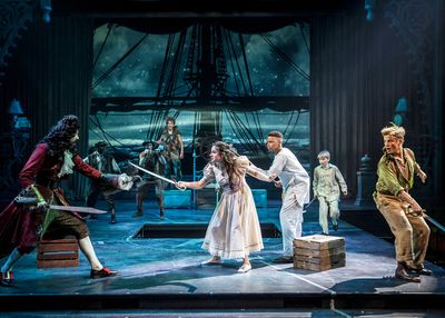 Wendy (Elizabeth Stenholt) spars with Captain Hook (James Konicek) as the Lost Boys t Photo
