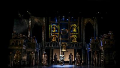 David  Burnham  (center)  as  Quasimodo  and  the  company. Photo